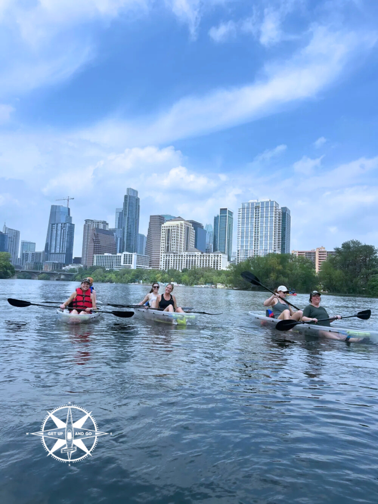 a group of people rowing a boat in the water
