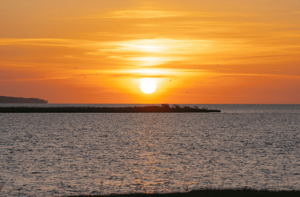 a sunset over a body of water