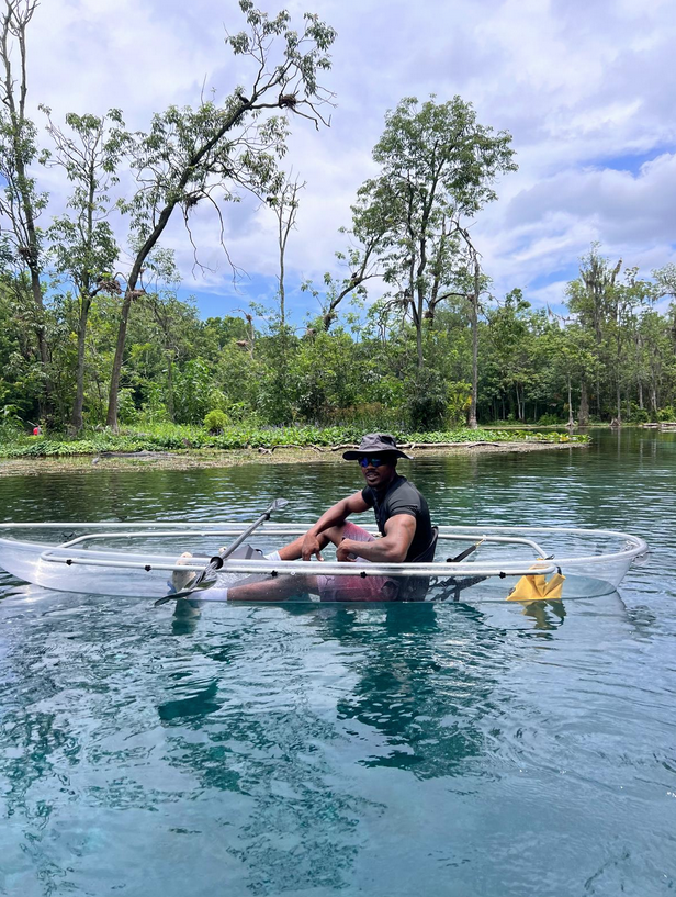 a person riding on the back of a boat in the water