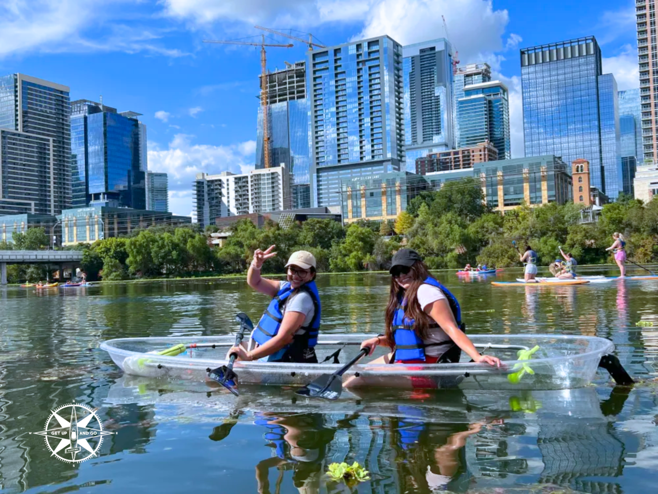 a group of people riding on the back of a boat in the water