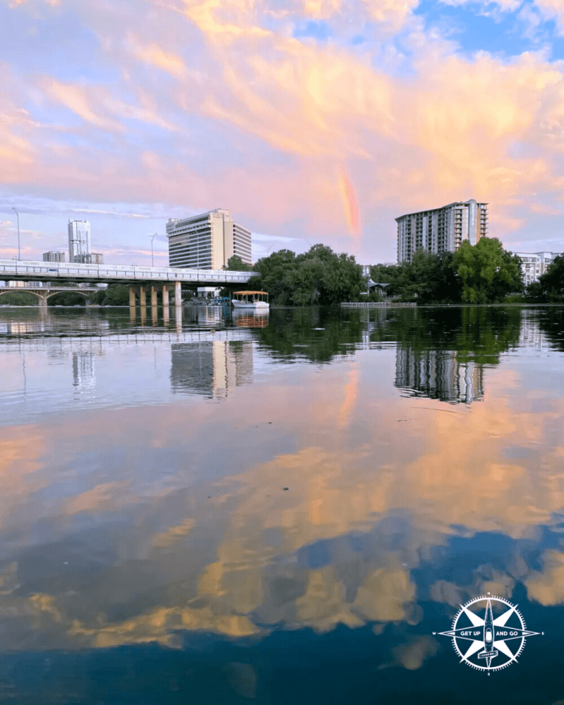 a body of water with a city in the background