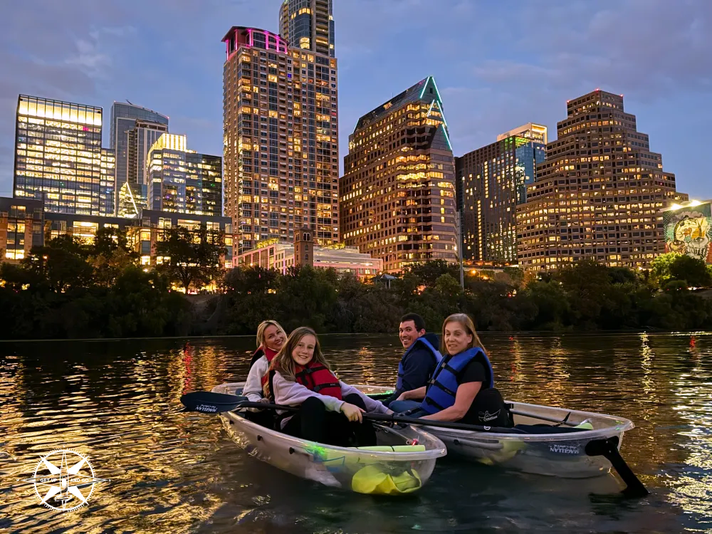 a group of people riding on the back of a boat in the water