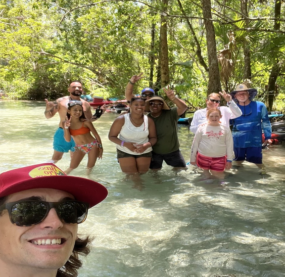 a group of people standing in a river