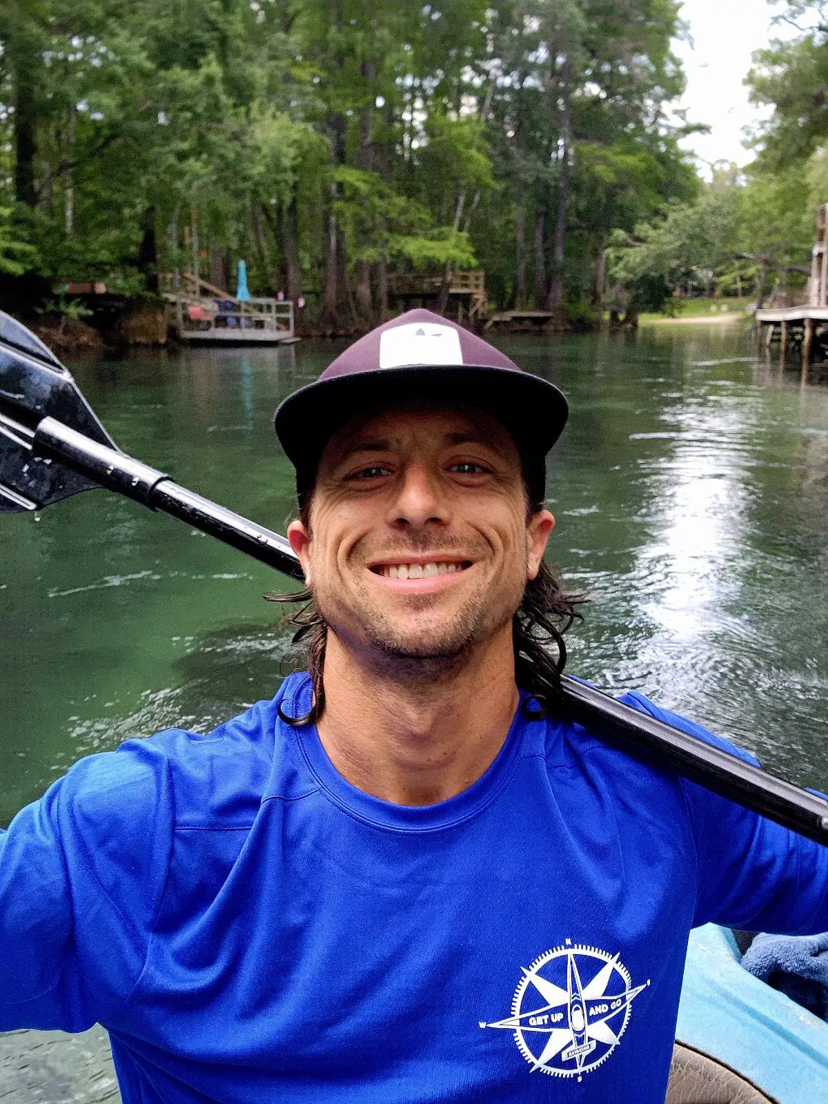 a person riding on the back of a boat in the water