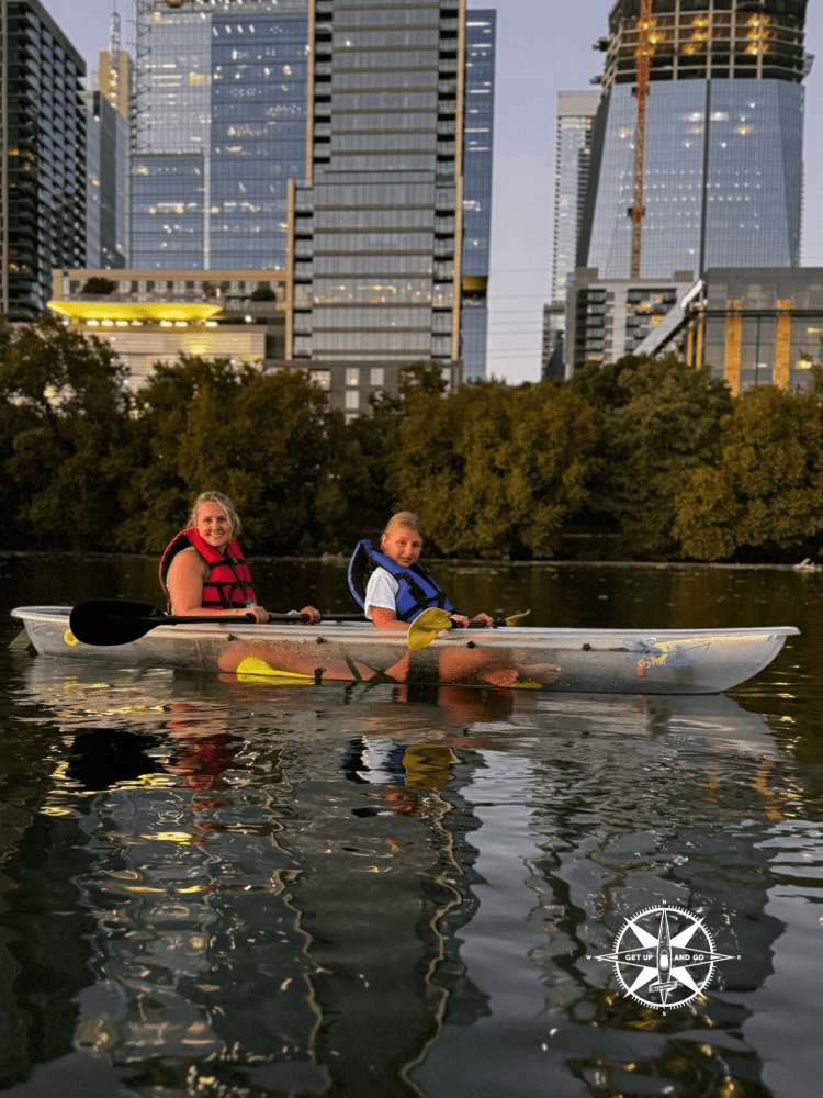 a group of people riding on the back of a boat in the water