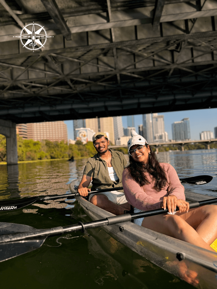 a group of people rowing a boat in the water