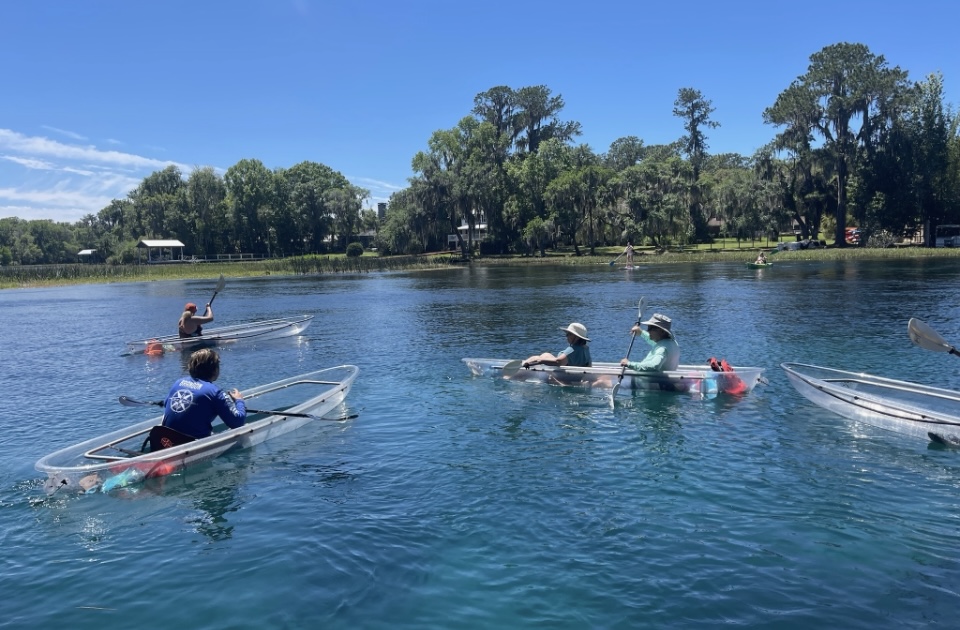 a group of people rowing a boat in the water