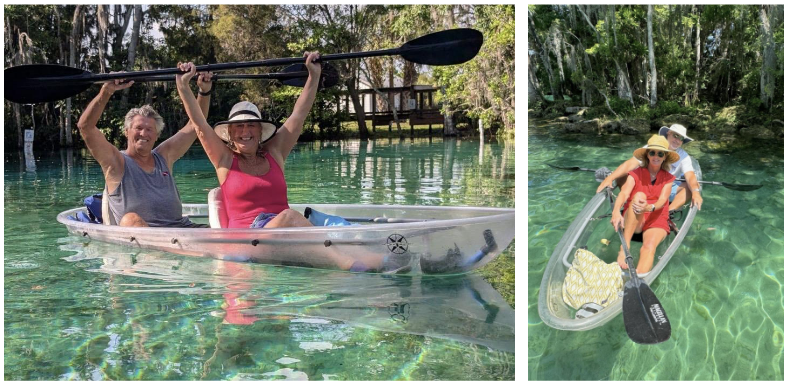 Two clear kayaks with two people each, paddling on a clear, sunny lake surrounded by trees.